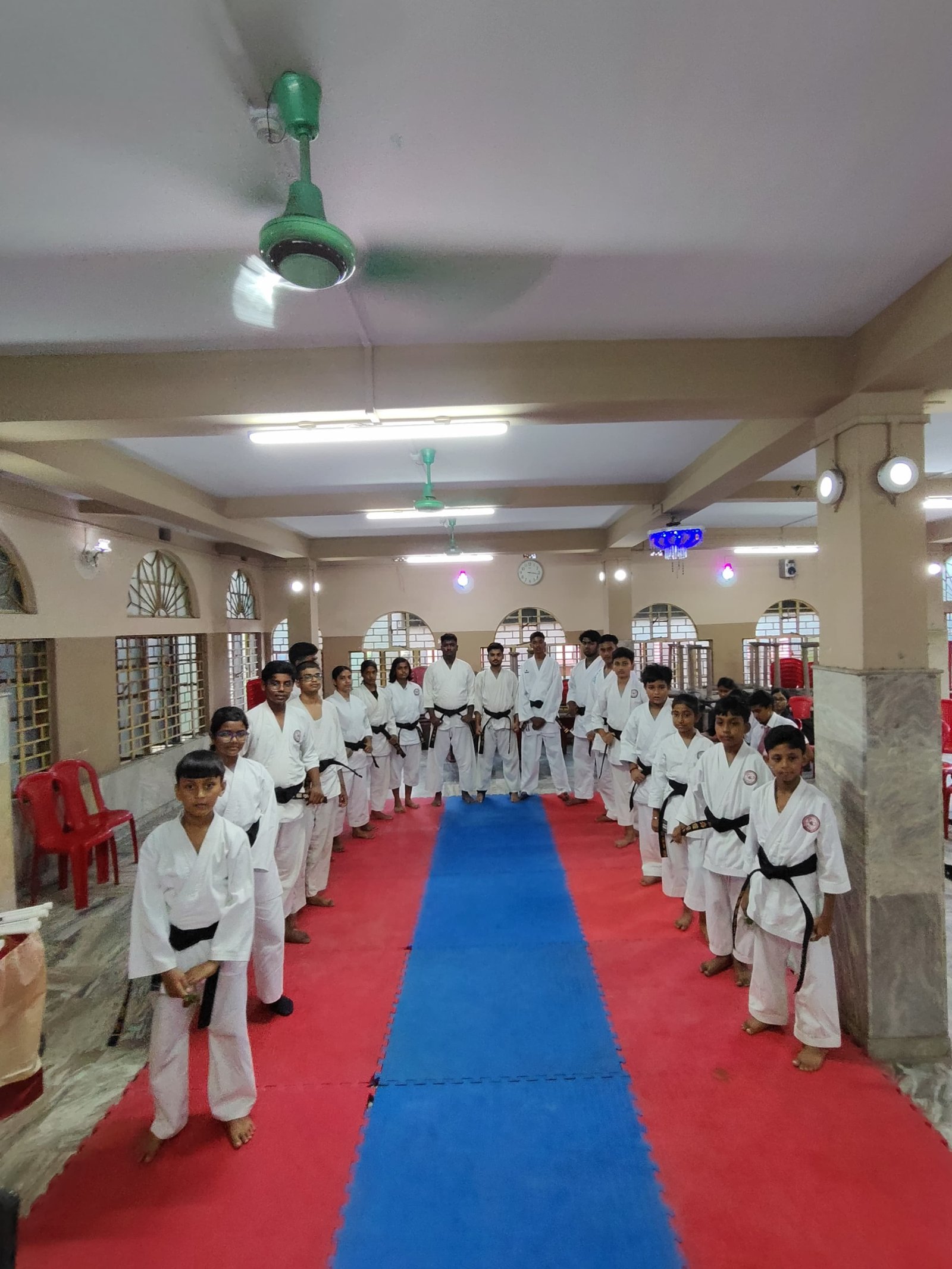 Instructors and recipients standing in formation in the corridor after the ceremony
