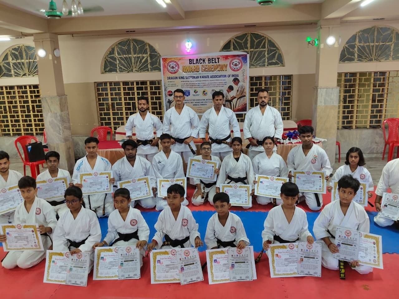 Black belt recipients posing with their award certificates