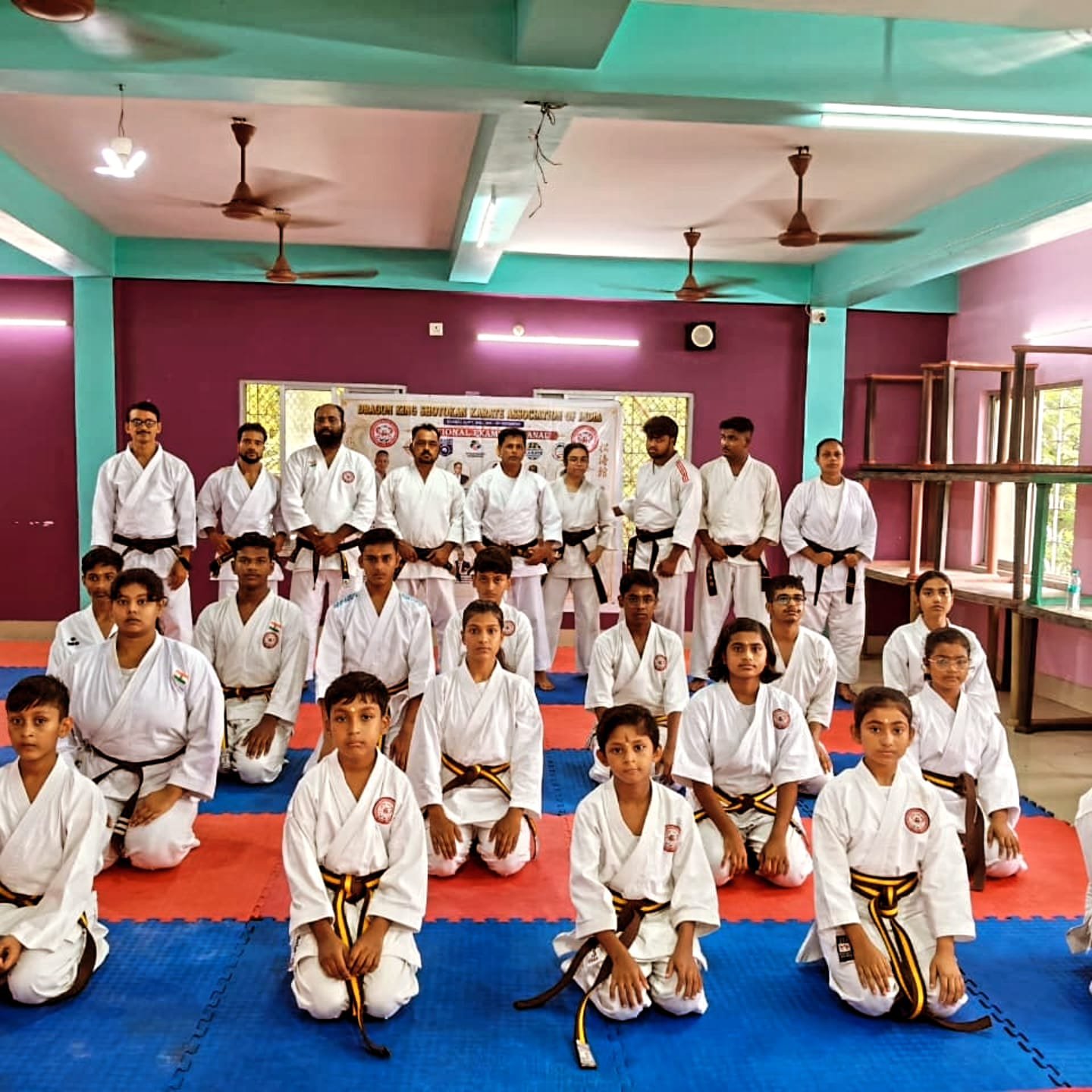 Group photo of black belt candidates and examiners before the Black Belt Dan Exam