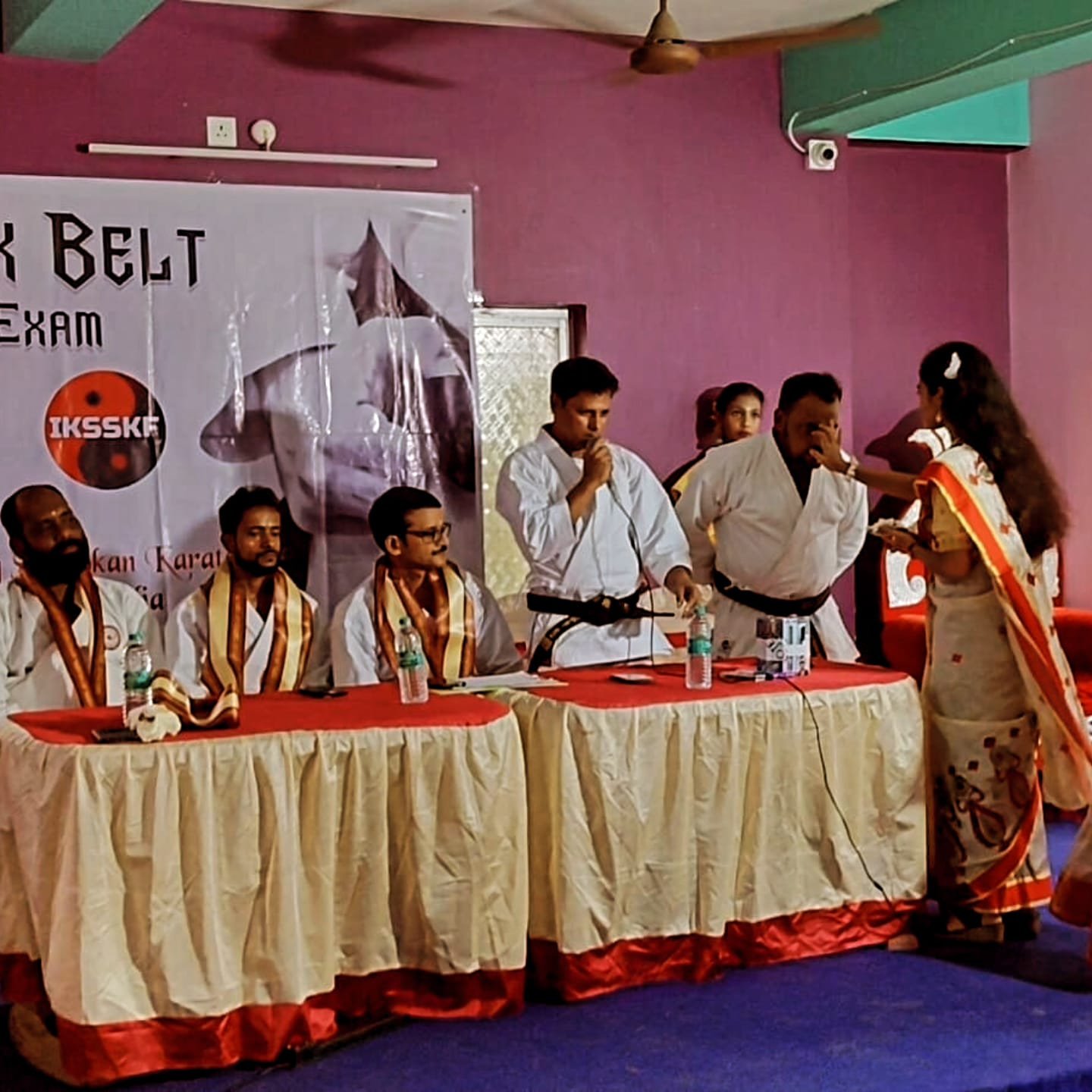 A candidate is honoured with a traditional sweet-feeding ceremony after the Black Belt Exam