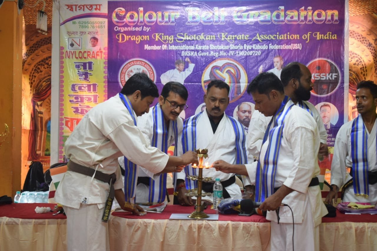 Senior instructors lighting the ceremonial lamp to open the Colour Belt Gradation exam program