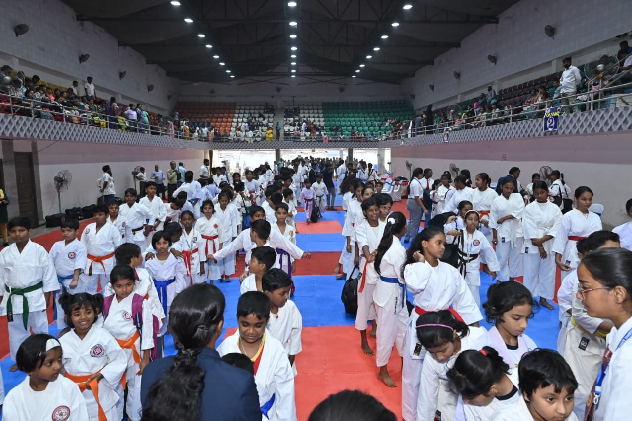 Competitors moving between mats inside the stadium during the tournament