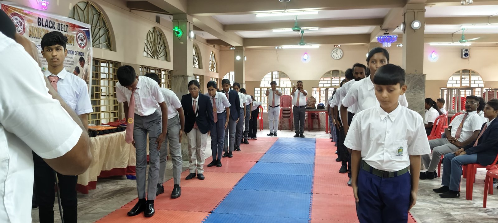 Students bowing in formation to begin a session
