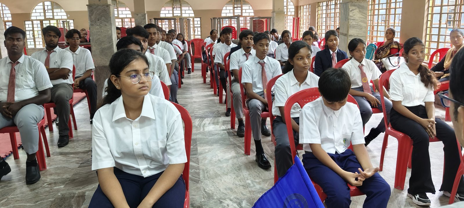 Students seated for the seminar briefing in the marble hall